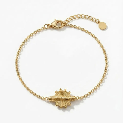 Gold bracelet with a unique clasp design on a white background