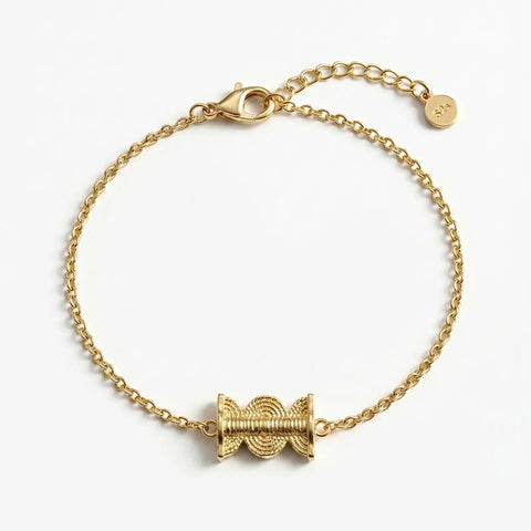 Gold bracelet with a unique clasp design on a white background