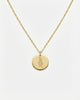 Gold necklace with a round pendant on a white background