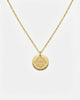 Gold necklace with a round pendant on a white background