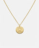 Gold necklace with a heart-shaped pendant on a white background