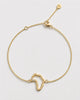 Gold bracelet with a unique design on a light gray background