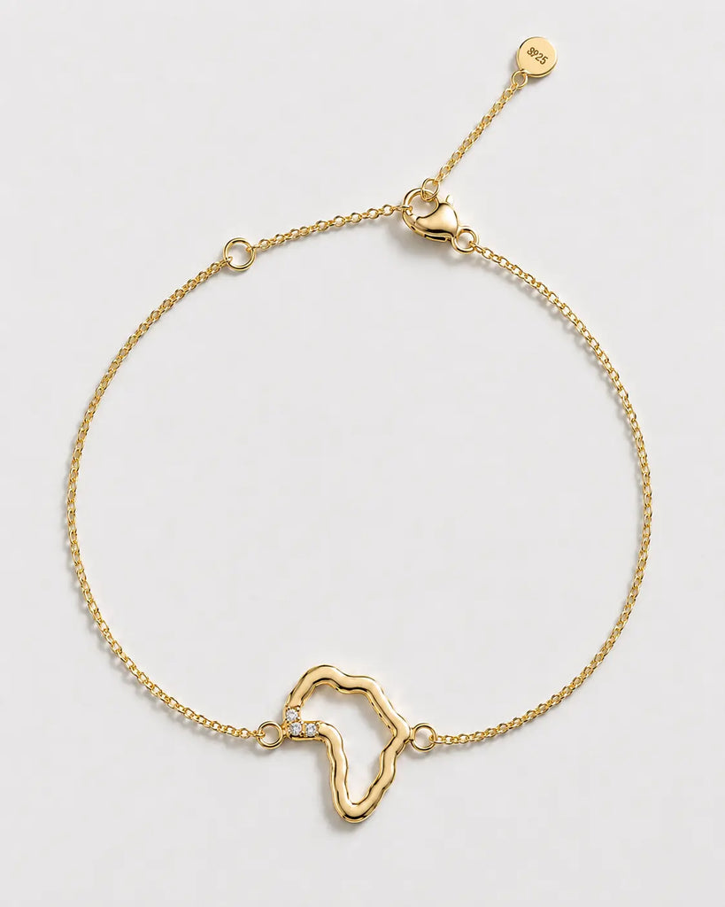 Gold bracelet with a unique design on a light gray background

