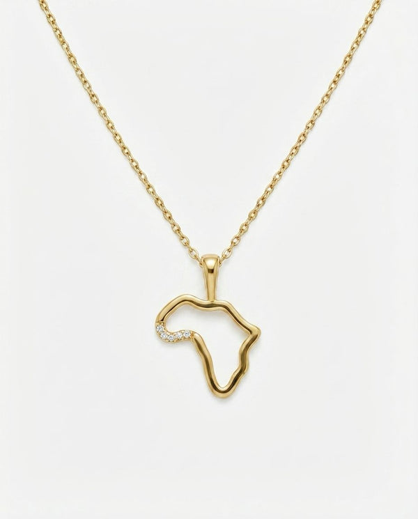 Gold necklace with a pendant shaped like the African continent on a white background